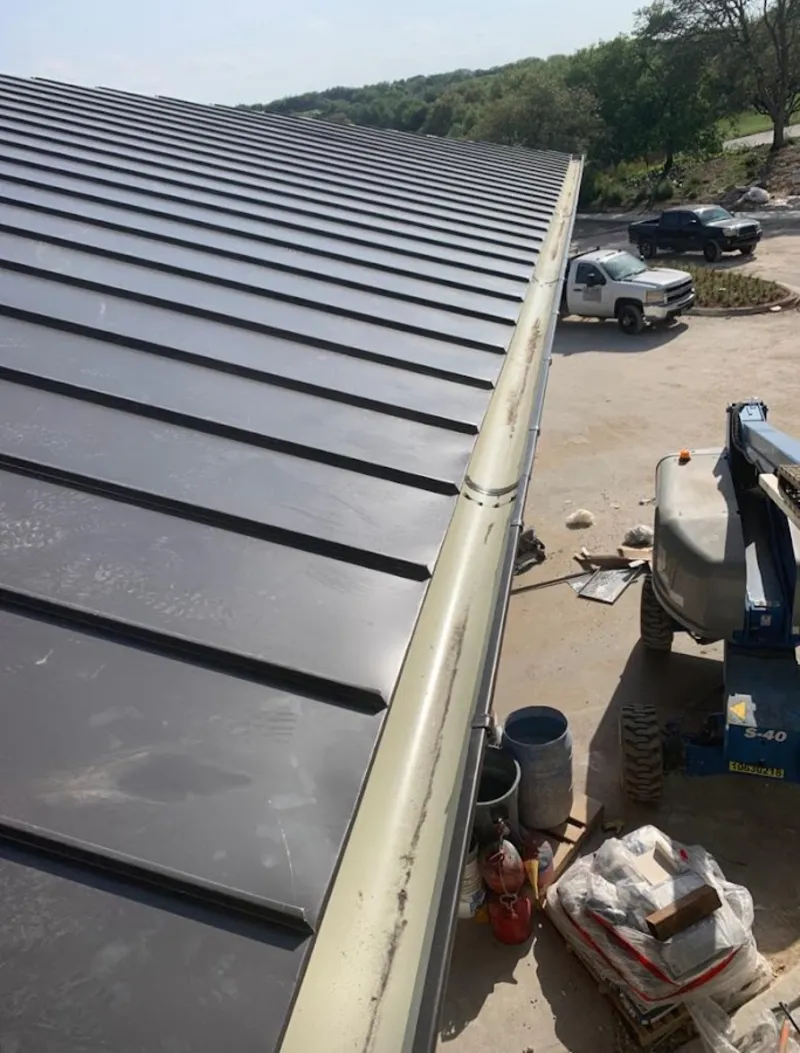 Standing seam panel and gutter detail on a metal roofing jobsite in West Hanover